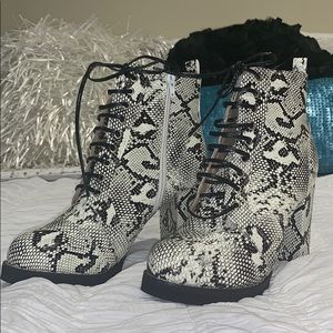Heeled snake print combat boots